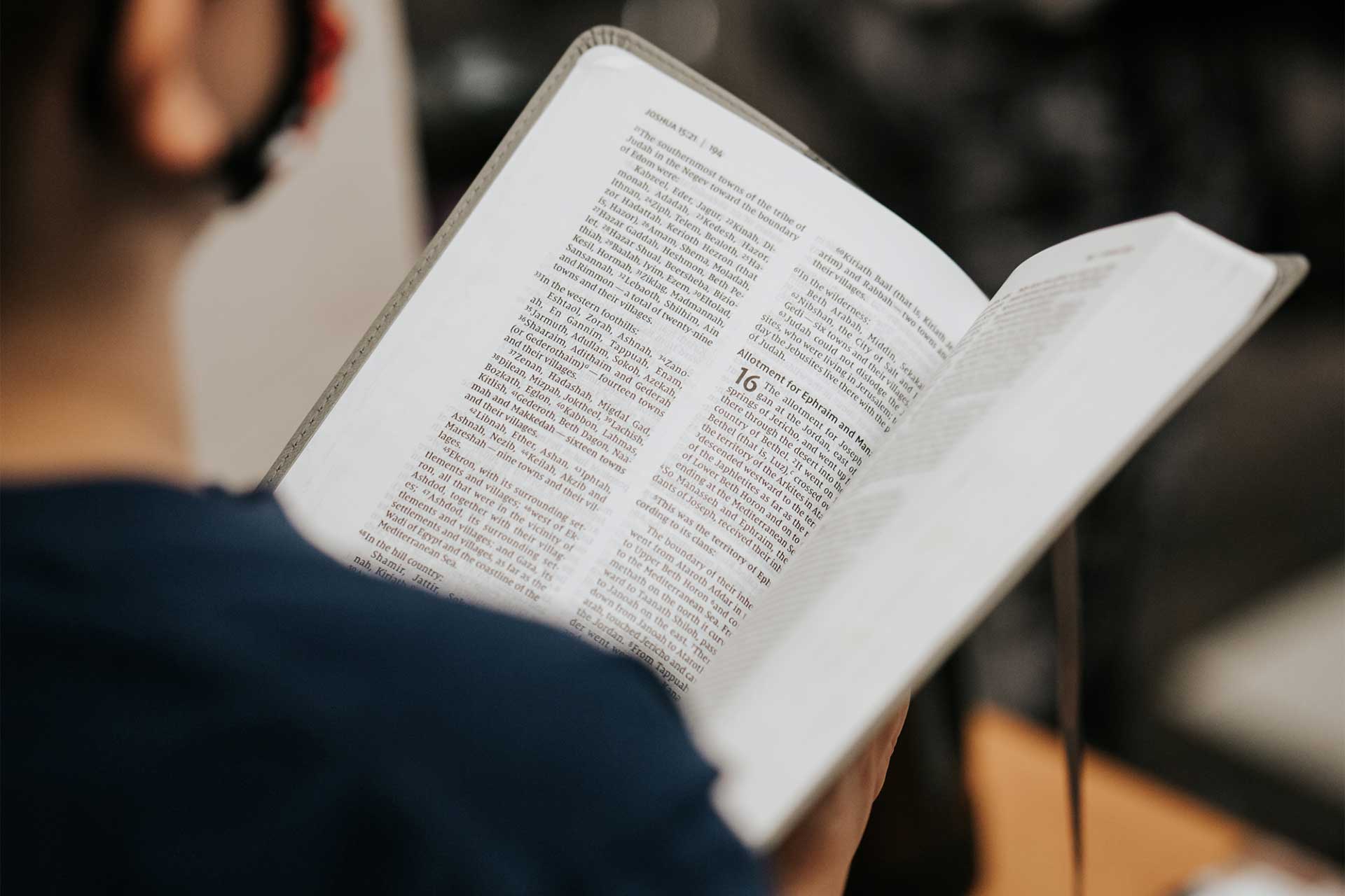 image of a person singing with their bible open.