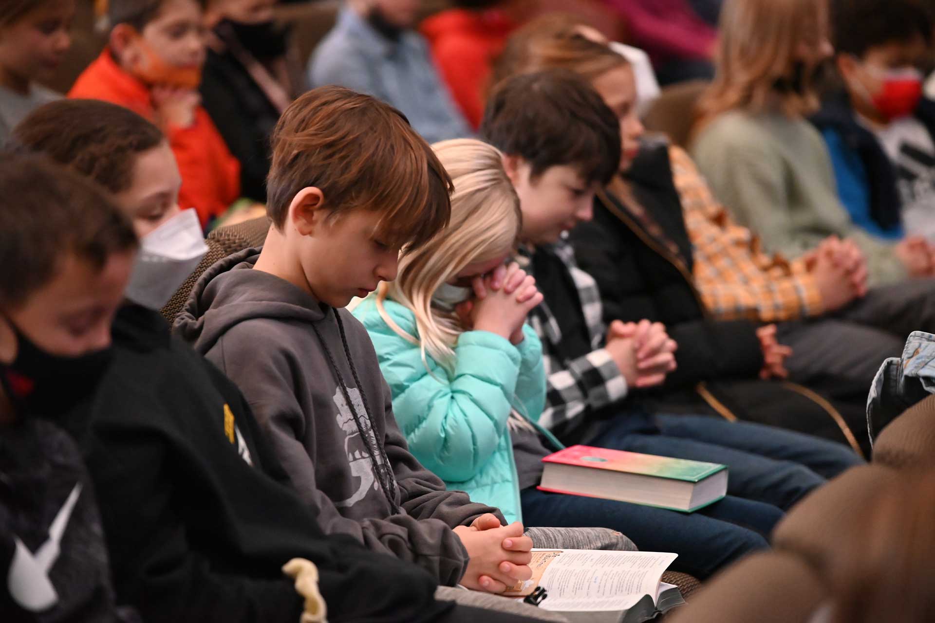 image of students praying in mass