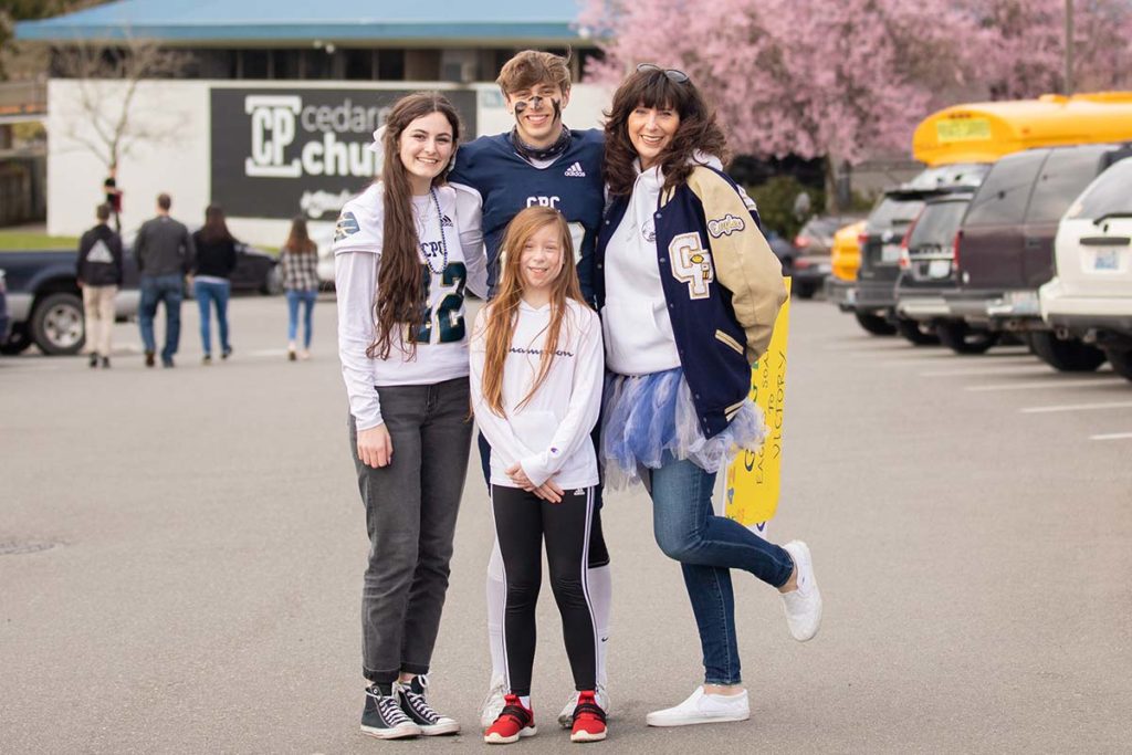 a family standing in the Cedar Park Bothell parking lot