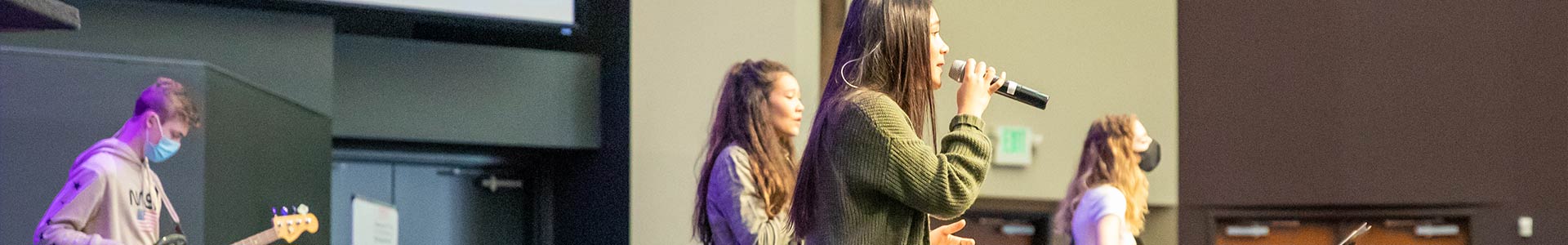 image banner of students performing on stage