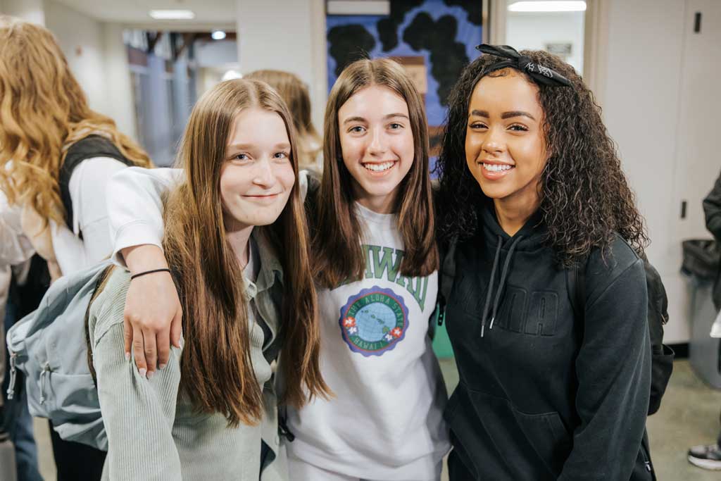 image of three female students smiling in a group