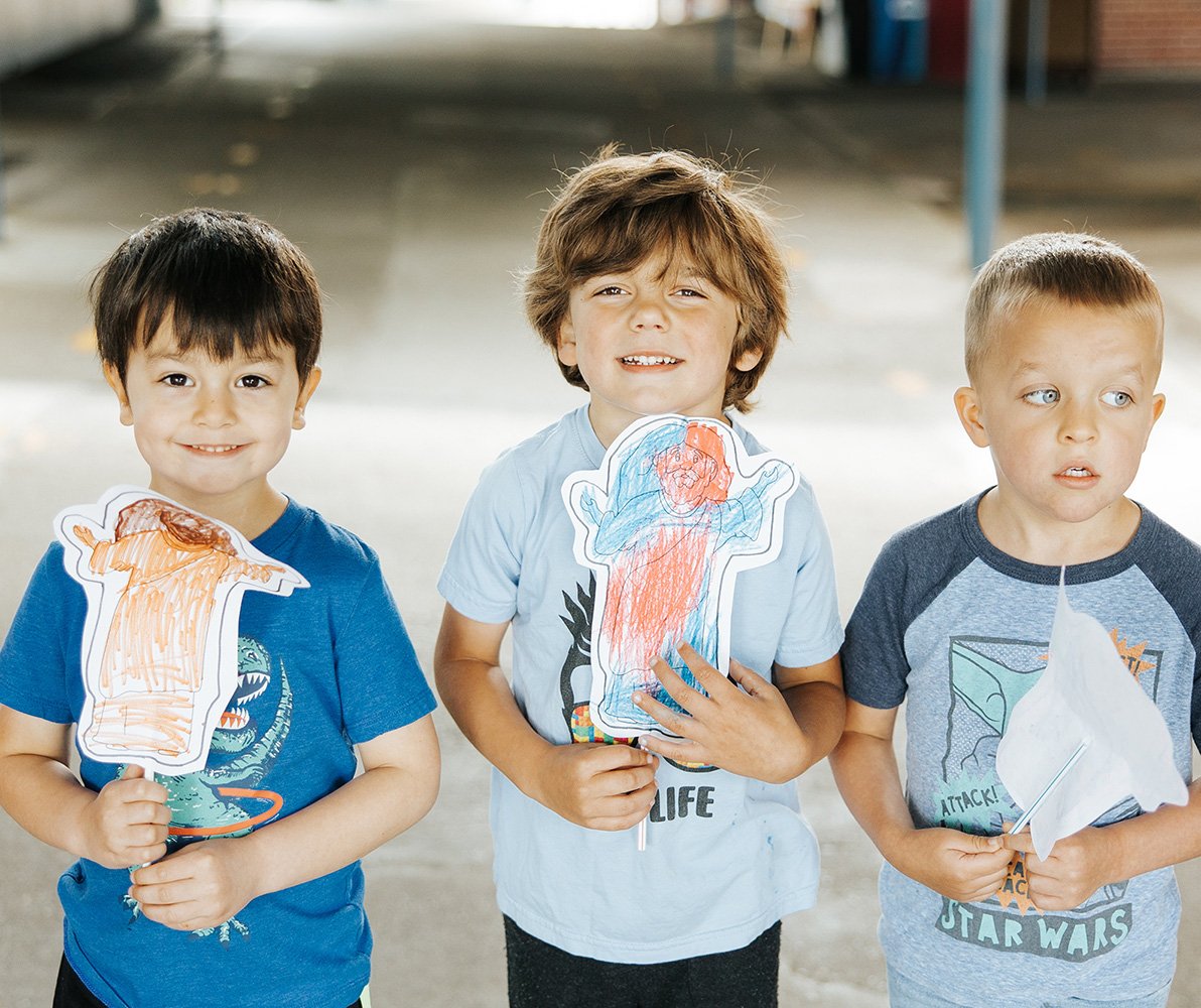 young children showing their artwork
