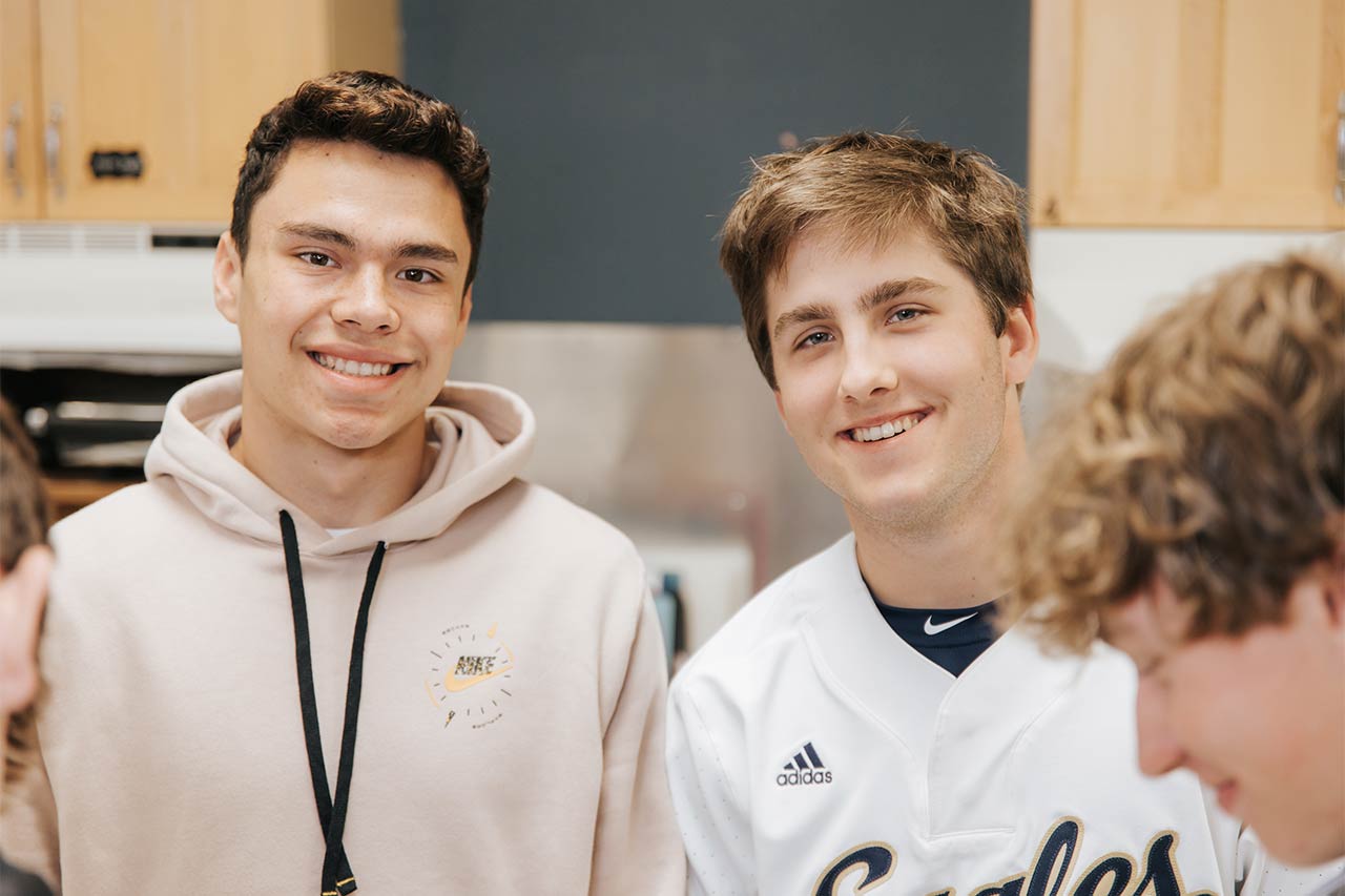 image of two high school friends smiling at the camera