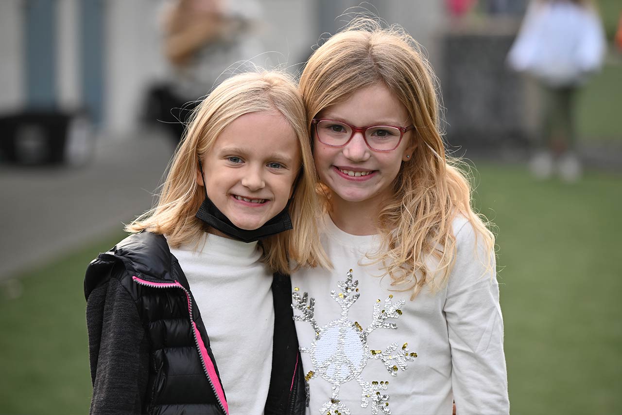 image of two girls hugging and smiling at the camera