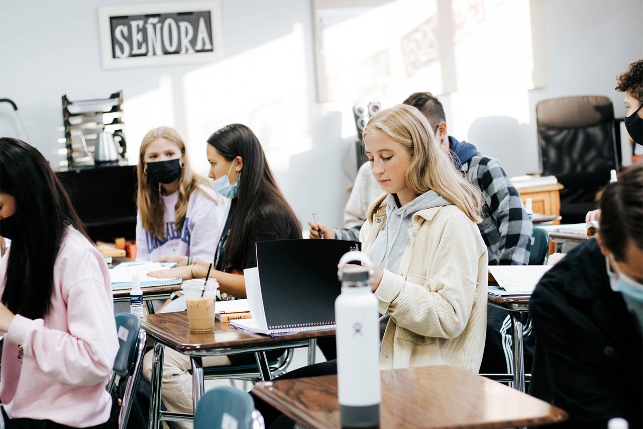 image of a female high school opening her binder in foreign language class