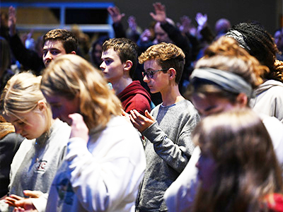 students worshipping in the sanctuary