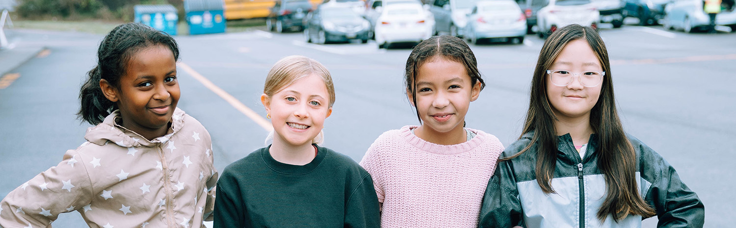 4 girls outside the school